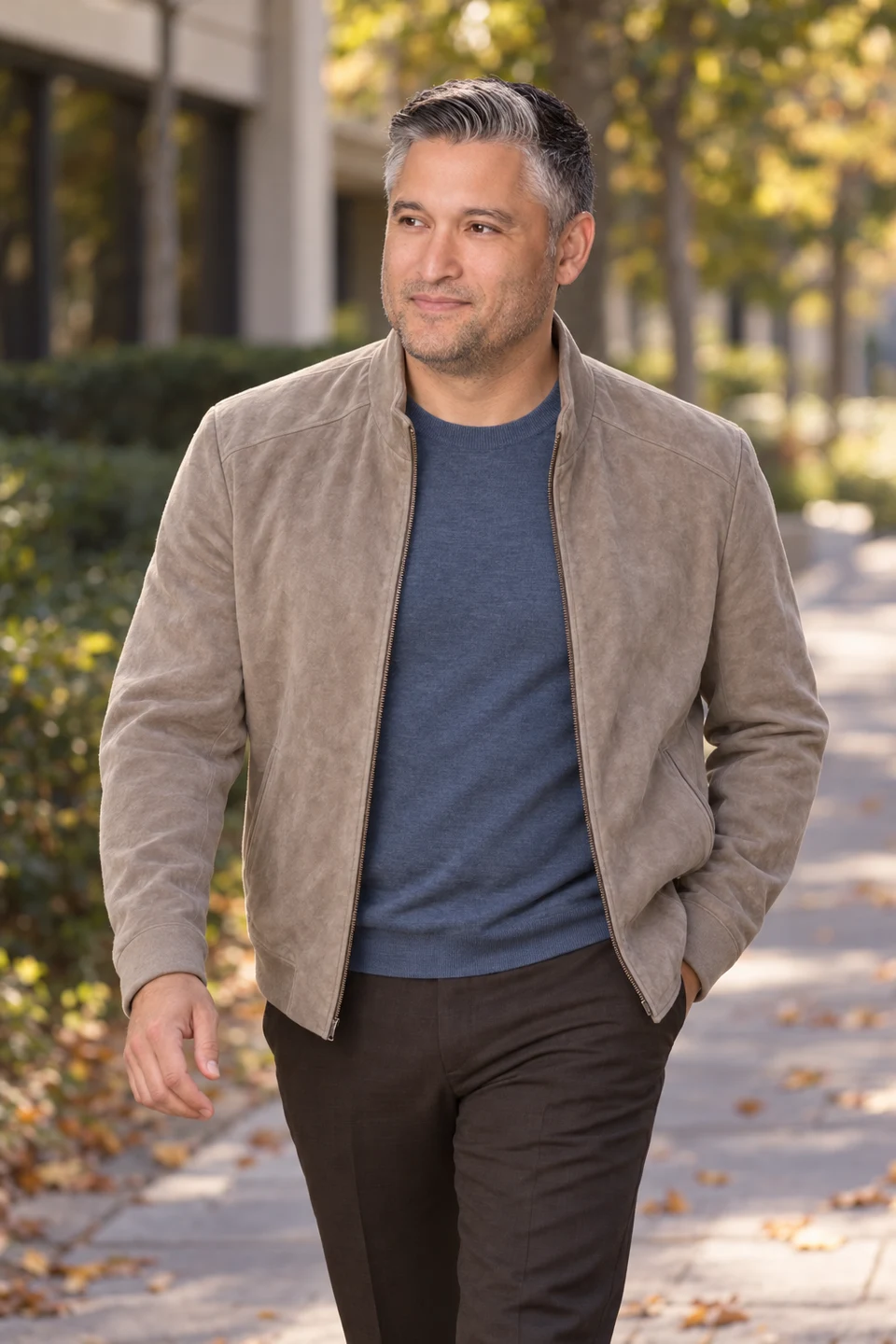 Creative portrait of Jim Butcher in a taupe jacket on a tree-lined path